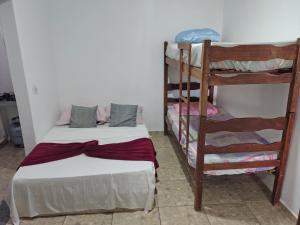 a bedroom with two bunk beds and a ladder at Kitnet Centro in Capitólio +4 photos