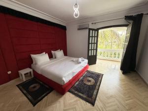 a bedroom with a large bed and a large window at Villa Anfa in Casablanca
