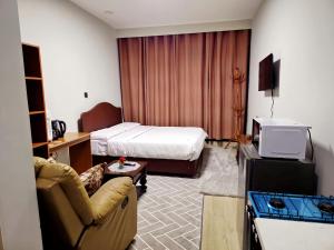 a hotel room with a bed and a couch at JKIA Transit Hub in Syokimau