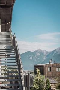 a stairway leading up to a building with mountains in the background at Tyrolhaus in Grinzens