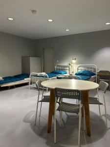 a room with a table and chairs and bunk beds at Freedom Studio Apartment in Berlin