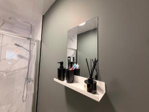 a bathroom with a mirror and a shelf with cosmetics at Brook Terrace in Darlington +26 photos