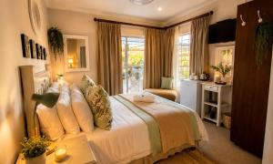 a bedroom with a large bed and a window at Ash River Lodge in Clarens