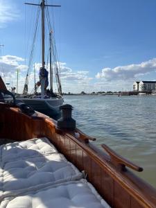 a boat is docked in the water next to a dock at Argovia Dutch Barge in Brightlingsea +22 photos