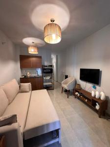a living room with a large bed and a kitchen at Agora resort north coast in Dawwār Abū Maḩrūs