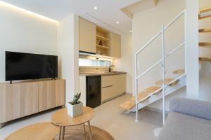 a living room with a flat screen tv on a wall at Villa Yanna in Olympiada