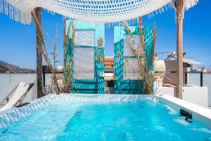 a swimming pool on the roof of a house at Malia Boutique Studios in Malia