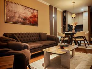 a living room with a couch and a table at Velvet Point apartmant in Kragujevac