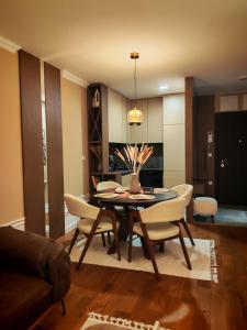a dining room with a table and chairs at Velvet Point apartmant in Kragujevac