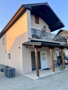 a house with a balcony on top of it at Apartman Rosić in Arilje