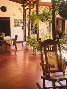 a room with a chair and a table with plants at La Casona Santa Fe in Santa Fe de Antioquia +7 photos