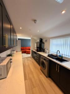 a kitchen with a sink and a washer and dryer at Brook Terrace in Darlington