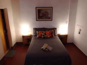 a bedroom with a bed with two lights and two tables at Departamento Monoambiente-Selva Stay Iguazu in Puerto Iguazú