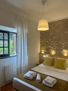 a bedroom with a bed with two towels on it at Casal Mala-Posta in Rio Maior