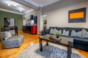 a living room with a couch and a table at 4 TRAVELERS Together in Thessaloniki +39 photos