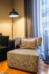 a living room with a chair and a lamp at 4 TRAVELERS Together in Thessaloniki
