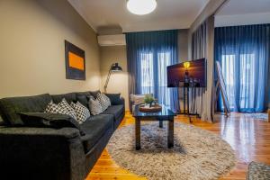 a living room with a couch and a table at 4 TRAVELERS Together in Thessaloniki