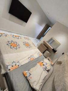 a bedroom with two beds and a flat screen tv at Nassim19 in Sétif