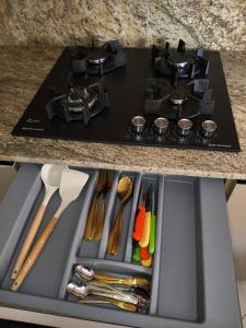 a kitchen sink with a stove top with utensils at Nassim19 in Sétif