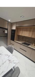 a kitchen with a table and chairs in a room at Nassim19 in Sétif