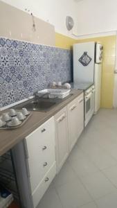a kitchen with a sink and a refrigerator at Green House in Briatico +11 photos