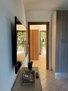 a living room with a table and a mirror at Casa Gaby in Gravedona