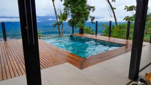 a swimming pool with a view of the ocean from a house at Kilamo sky glamping macas in Macas +9 photos