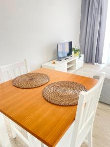 a dining room table with two large mats on it at Apartamento T0 - MedSal Residence in Prainha