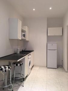 a kitchen with a sink and a stove and a dishwasher at Monaco Studio #3 with private patio in Beausoleil