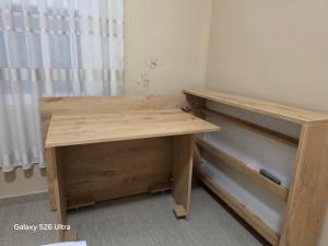 a wooden desk in a room with a shelf at Vila HOXHA in Hamallë
