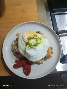 a plate of food with an egg and strawberries at Casa Chez Zoe in Salamansa