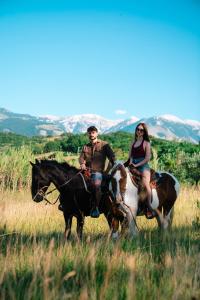 a man and a woman riding horses in a field at Borgo Majella by Rentbeat in Abbateggio +63 photos