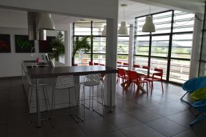 a kitchen and dining room with a table and chairs at L'Aquarium Attigneville in Attignéville