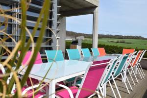 a table and chairs on a patio with a view at L'Aquarium Attigneville in Attignéville