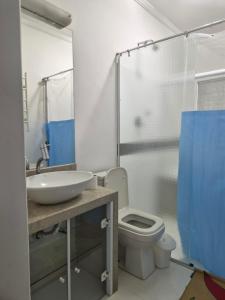 a bathroom with a sink and a toilet and a shower at Refúgio triplo por pessoa in Paulínia