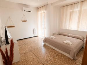 a bedroom with a bed and a large window at Savona Casa Dolce Vita in Savona