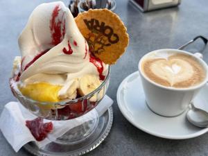a cup of coffee and a bowl of ice cream at Savona Casa Dolce Vita in Savona