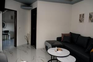 a living room with a couch and a table at Angels luxury villa in Kastamonítsa
