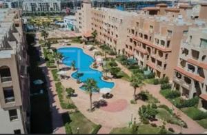 an aerial view of a resort with a swimming pool at Agora resort north coast in Dawwār Abū Maḩrūs +3 photos