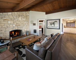 a living room with a couch and a fireplace at Oceanpoint Ranch in Cambria
