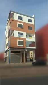 a tall apartment building with a garage at Spinoza House Agadir City Apartment in Agadir