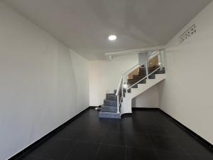 an empty room with a staircase in a building at C-Appart Residence in Tuléar +1 photo