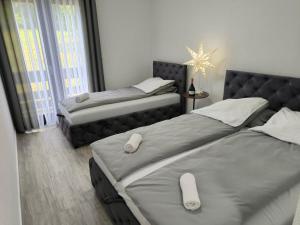 a bedroom with two beds and a star on the wall at Hotel Vuković in Han Pijesak