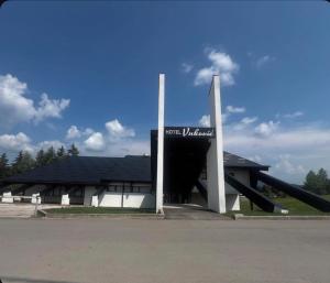 a building with a slide in front of it at Hotel Vuković in Han Pijesak
