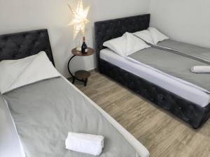 a bedroom with two beds and a table with a star at Hotel Vuković in Han Pijesak +2 photos