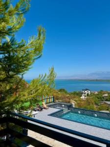 a swimming pool with a view of the water at Lakeside Villas & Jacuzzi Suites in Shirokë