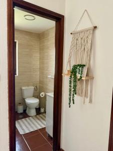 a bathroom with a white toilet at Miradouro 13 - Gerês in Geres +21 photos