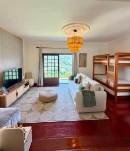 a living room with a couch and bunk beds at Miradouro 13 - Gerês in Geres