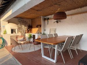 a dining table and chairs on a patio at Miradouro 13 - Gerês in Geres