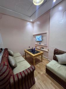 a living room with a couch and a tv at velaris in Chefchaouen +10 photos